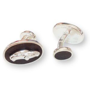 A pair of cufflinks with the image of a car on them.