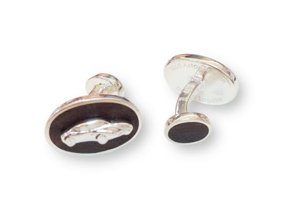 A pair of cufflinks with the image of a car on them.