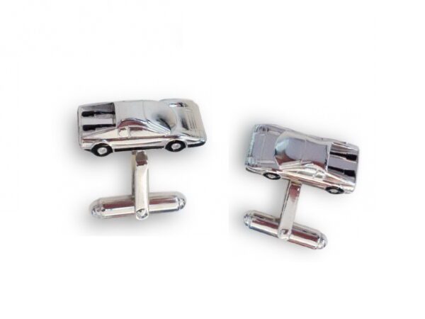 A pair of cufflinks with a car on them.