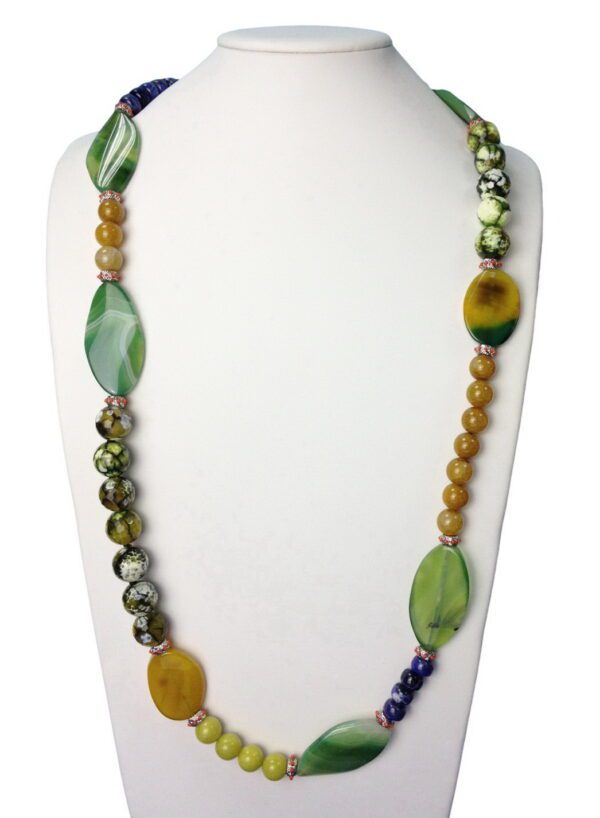 A white display stand with a necklace of green and yellow beads.