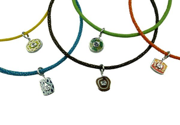 A group of necklaces with different colored cords.