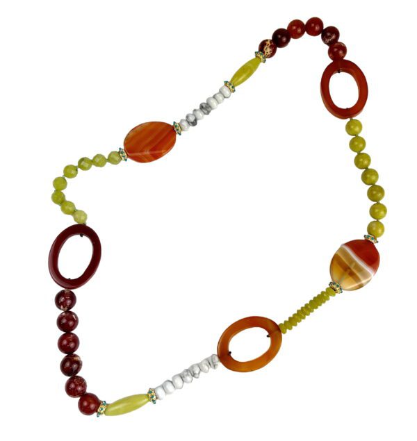 A long necklace with various colored beads and rings.