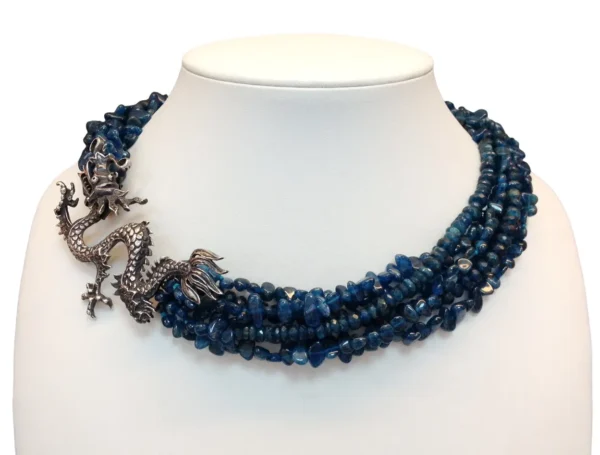 A necklace with blue beads and silver dragon