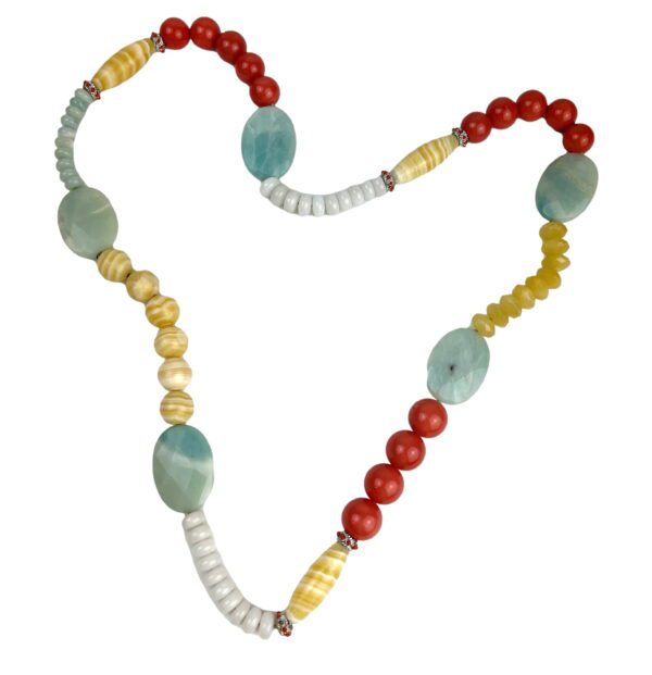 A heart shaped necklace with beads and stones.