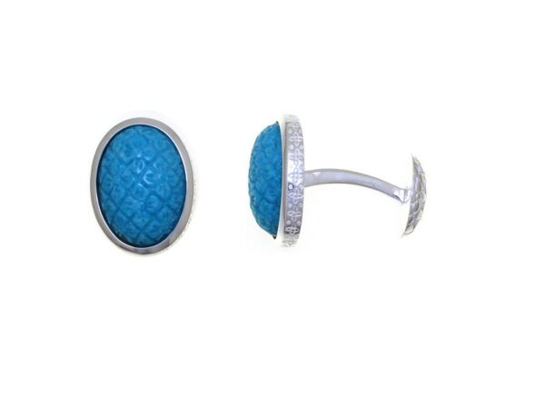 A pair of Carved Turquoise Tile cufflinks featuring blue textured centers surrounded by silver frames, displayed on a white background.