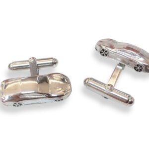 A pair of cufflinks with a car on them.