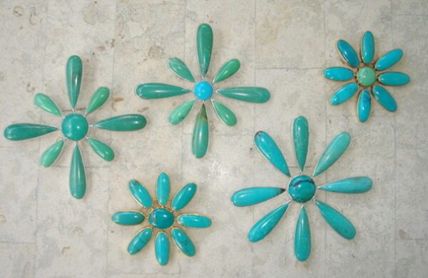 A group of turquoise flowers on the floor.