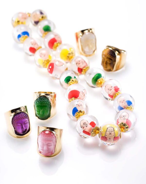 A group of colorful beads and rings on white.