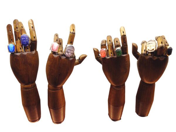 A wooden hand with many different objects in it