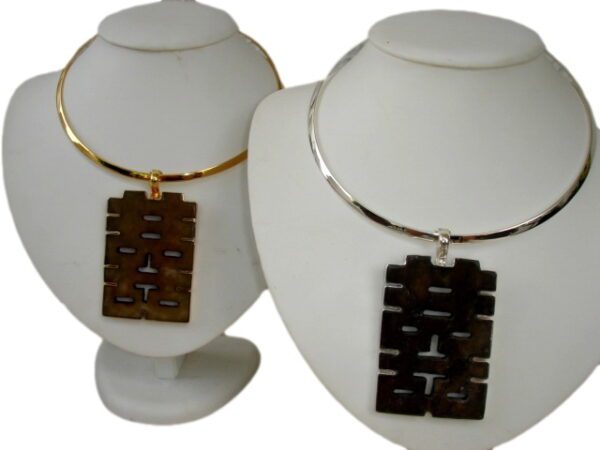 Two Wire Necklaces displayed on white stands, each featuring a gold hoop and a rectangular pendant with a cut-out geometric design.