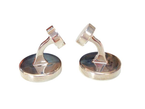 A pair of silver cufflinks with a geometric design.