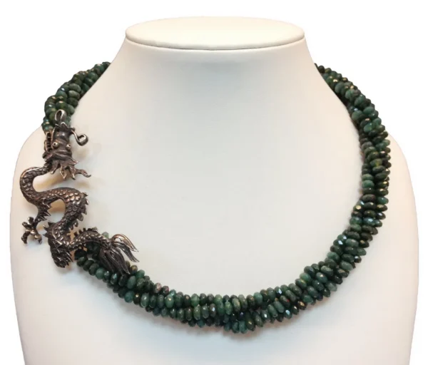 A necklace with green beads and silver dragon clasp.