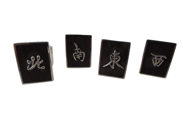 A set of four black and silver magnets with chinese symbols.