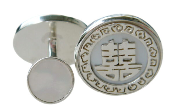 A pair of silver earrings with chinese symbols.