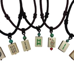 Necklaces with pendants featuring various printed and engraved designs on Antique Mah Jong Tiles, strung with green and red beads on knotted black cords.