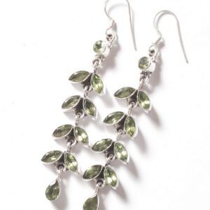A pair of silver earrings with green leaves.