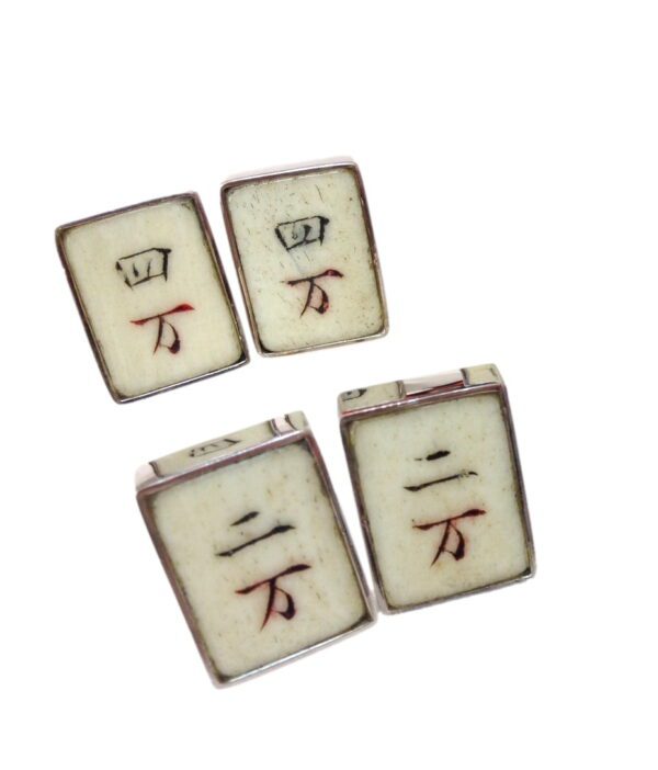 A set of four tiles with the word " mahjong " written in red ink.