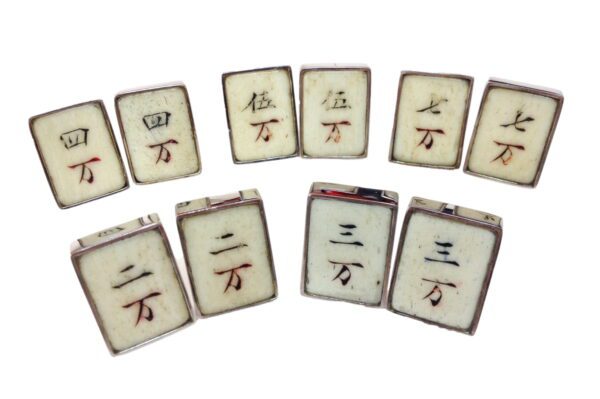 A group of ten white tiles with chinese characters on them.