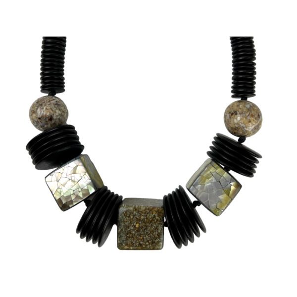 A necklace with black and white beads on it.