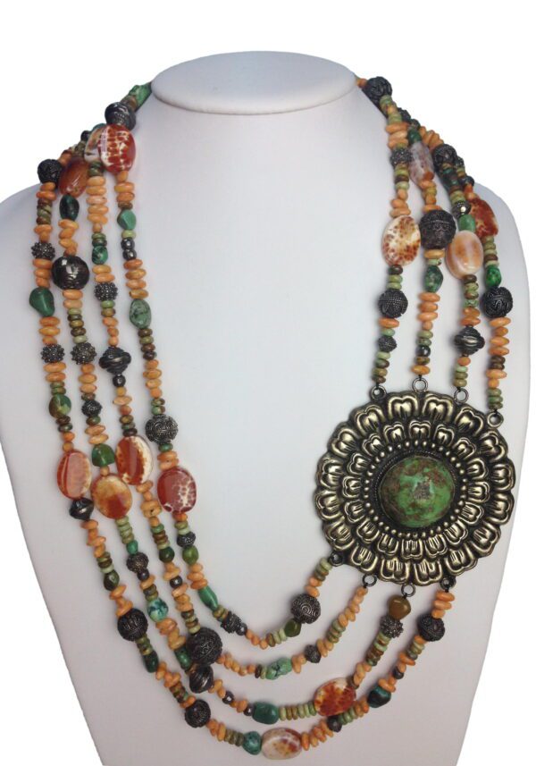 A necklace with multiple strands of beads and a large pendant.