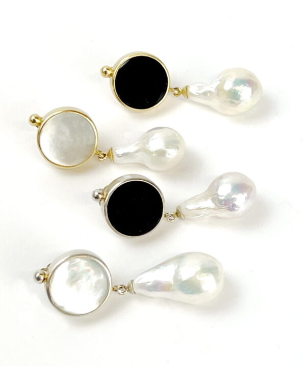 A set of four pairs of earrings with pearls and black stones.