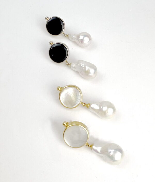 A row of four different earrings on top of each other.