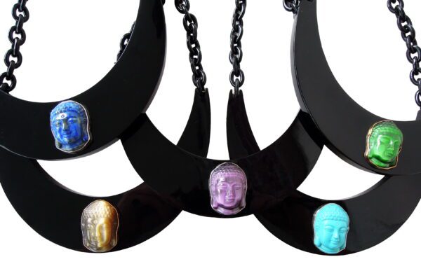 A group of three necklaces with different colored stones.