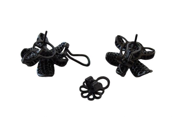 A pair of black ornate metal Orchid Earrings designed with floral accents, isolated on a white background.