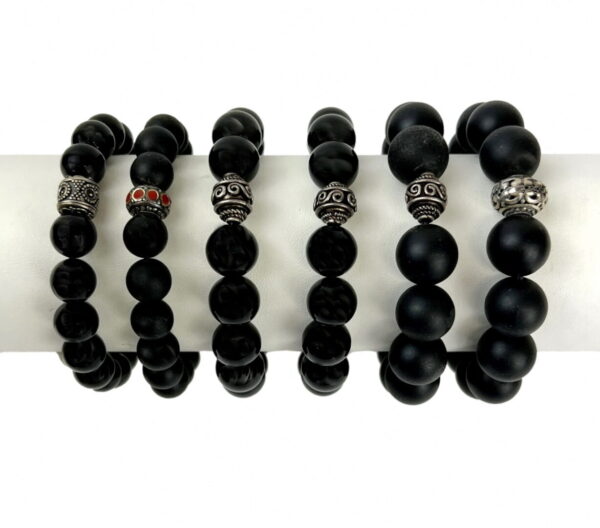 A row of black bracelets with silver beads.