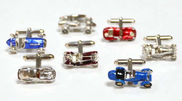 A group of cufflinks that are shaped like cars.