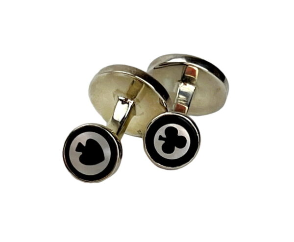 A pair of cufflinks with the image of a card suit.