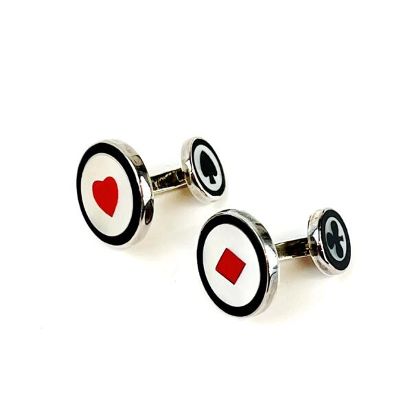 A pair of cufflinks with a red heart and black circle.