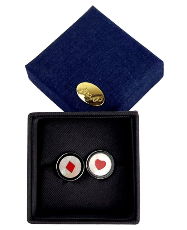 A pair of cufflinks with hearts and diamonds.