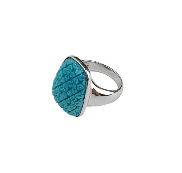 A silver ring with a blue stone on it.