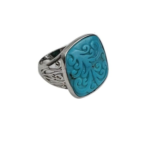 A silver ring with a blue stone on it's side.