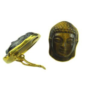 A gold buddha head and a black stone
