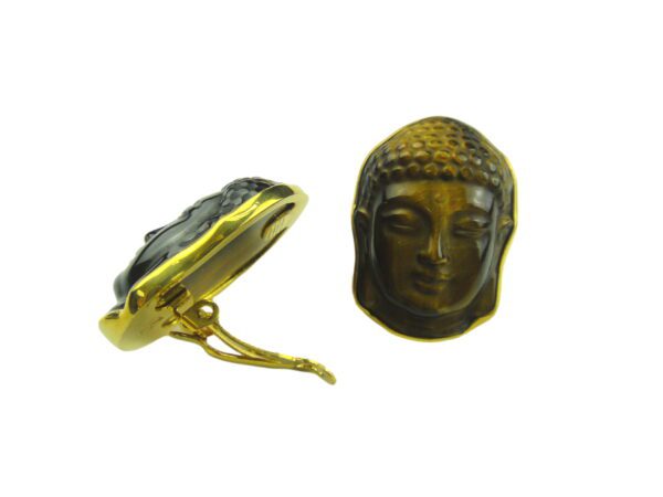 A gold buddha head and a black stone