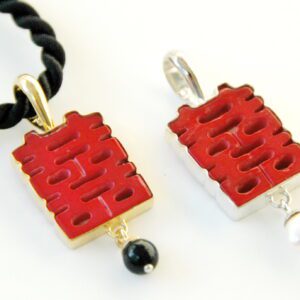 A couple of red pendants sitting next to each other.