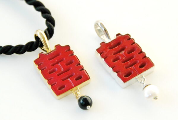 A couple of red pendants sitting next to each other.