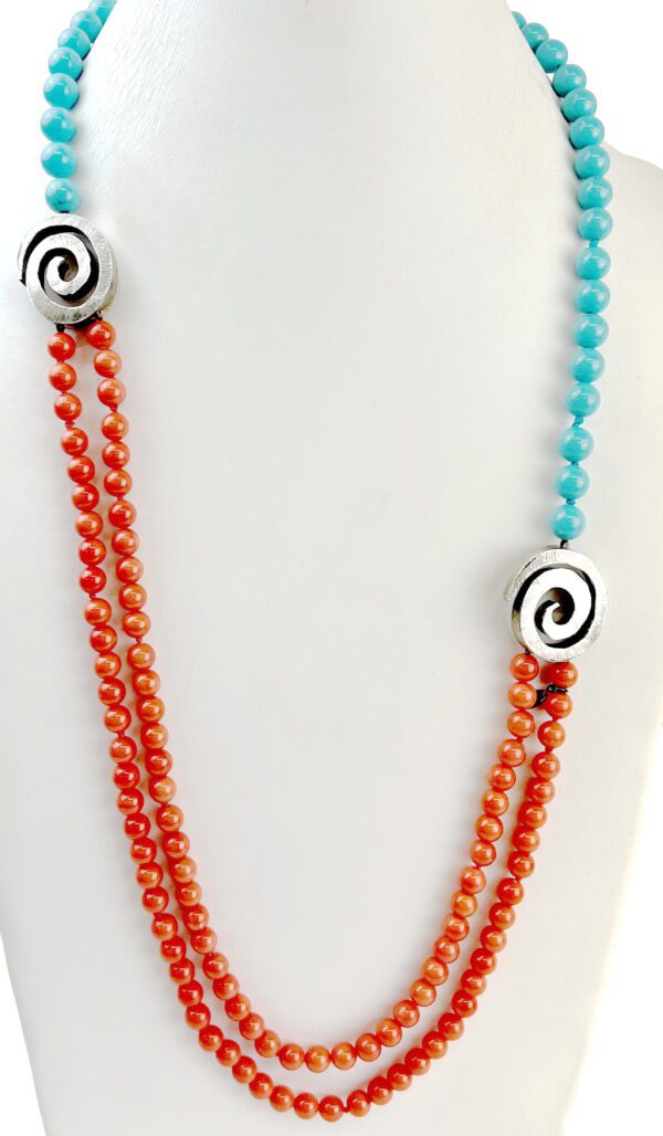 A necklace with two strands of beads and a spiral.