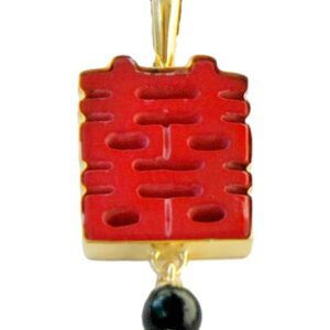 A red and gold pendant with an oriental design.
