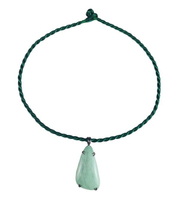 A green necklace with a large stone hanging from it.