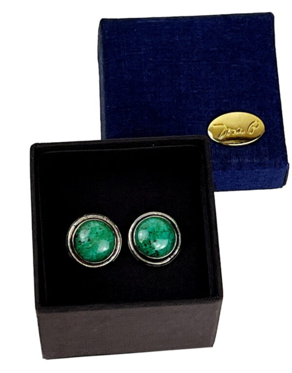 A pair of green earrings in a box.