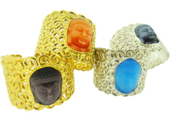 Four Ming Cloud Cuffs with carved Buddha faces in different colors – orange, blue, black, and white – set against a white background.