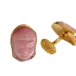 A pair of pink buddha cufflinks with gold trim.