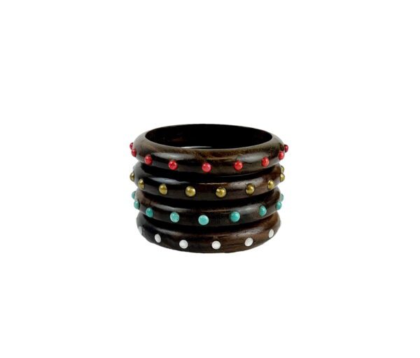 A stack of four wooden bangles with colored stones.