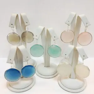 A display of three pairs of earrings in different colors.