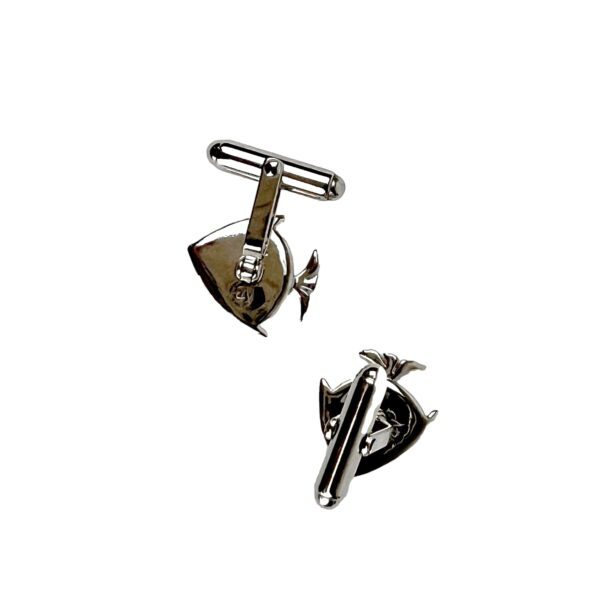 A pair of silver cufflinks with a propeller and a boat.