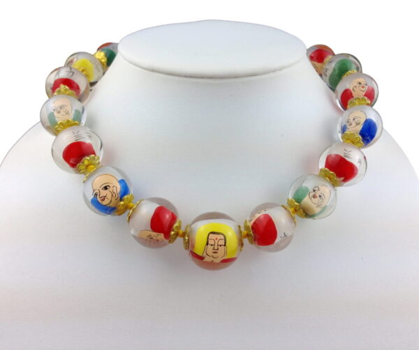 A necklace of glass beads with faces on them.
