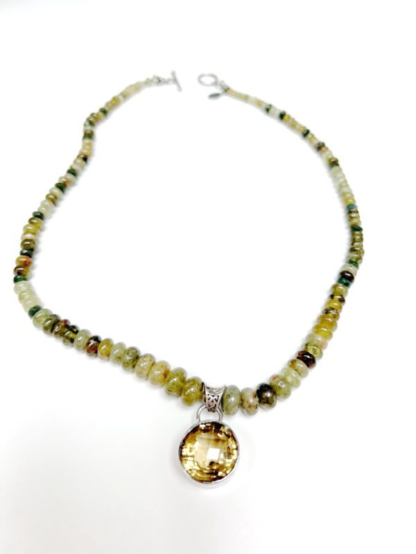 A necklace with a yellow and green bead.